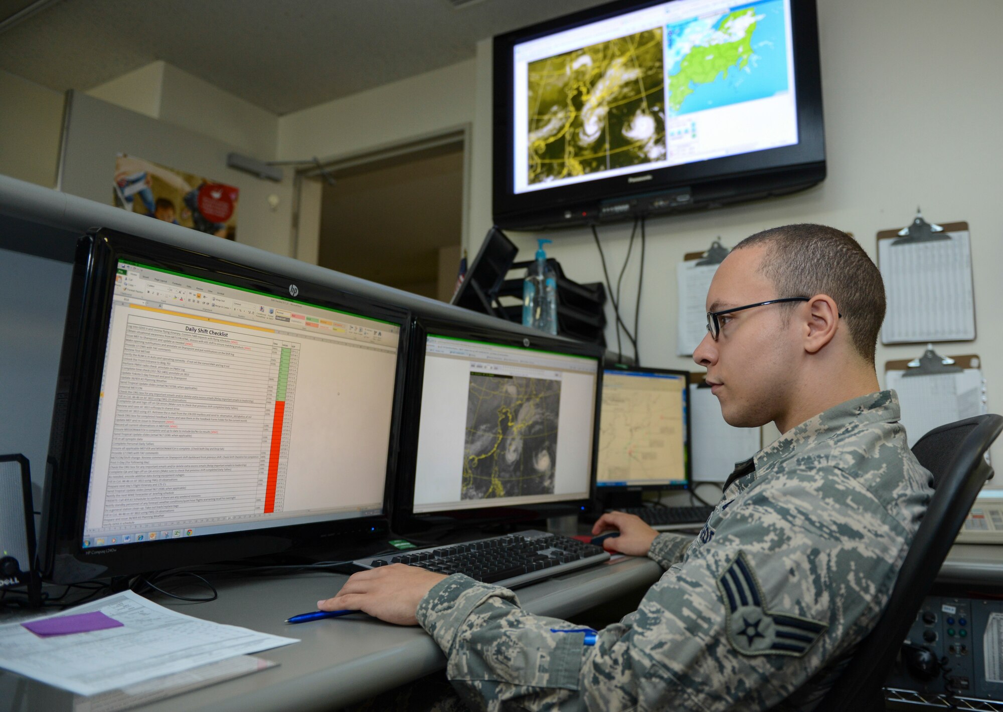 Senior Airman Dimitreus Newell, 374th Operational Support Squadron Weather Flight weather forecaster, reviews a weather flight daily checklist at Yokota Air Base, Japan, Oct. 24, 2013. As the name implies, the list has everything Airmen need to accomplish such as issuing a five-day forecast. (U.S. Air Force photo by Senior Airman Michael Washburn/Released)