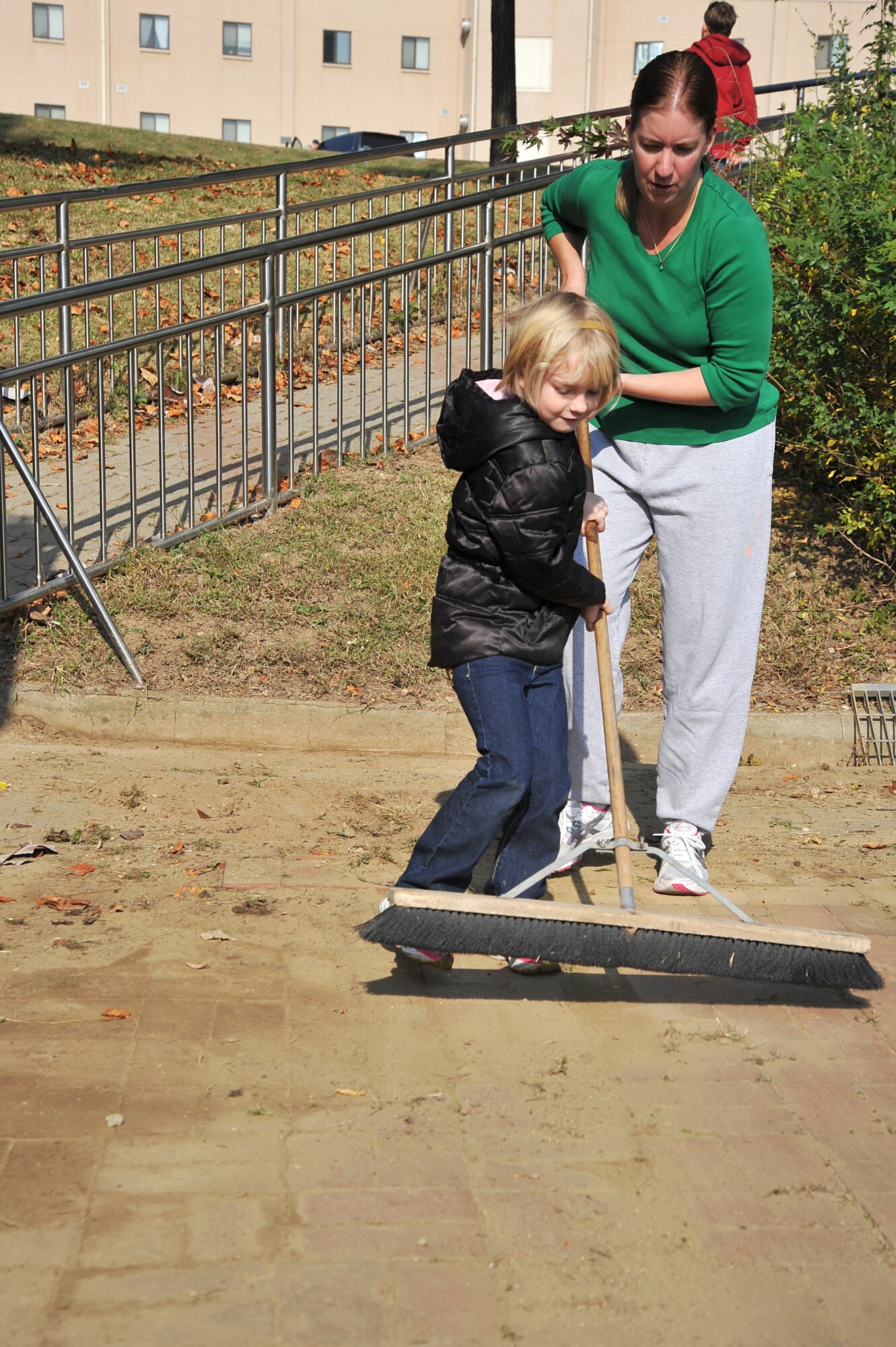 April Honaker, an Airman’s spouse, and her daughter Emily, 7, help clean up the Mustang Valley Park at Osan Air Base, Republic of Korea, Oct. 26, 2013. Parents were happy to have their kids take part in making the park a better and safer place. (U.S. Air Force photo/Staff Sgt. Emerson Nuñez)