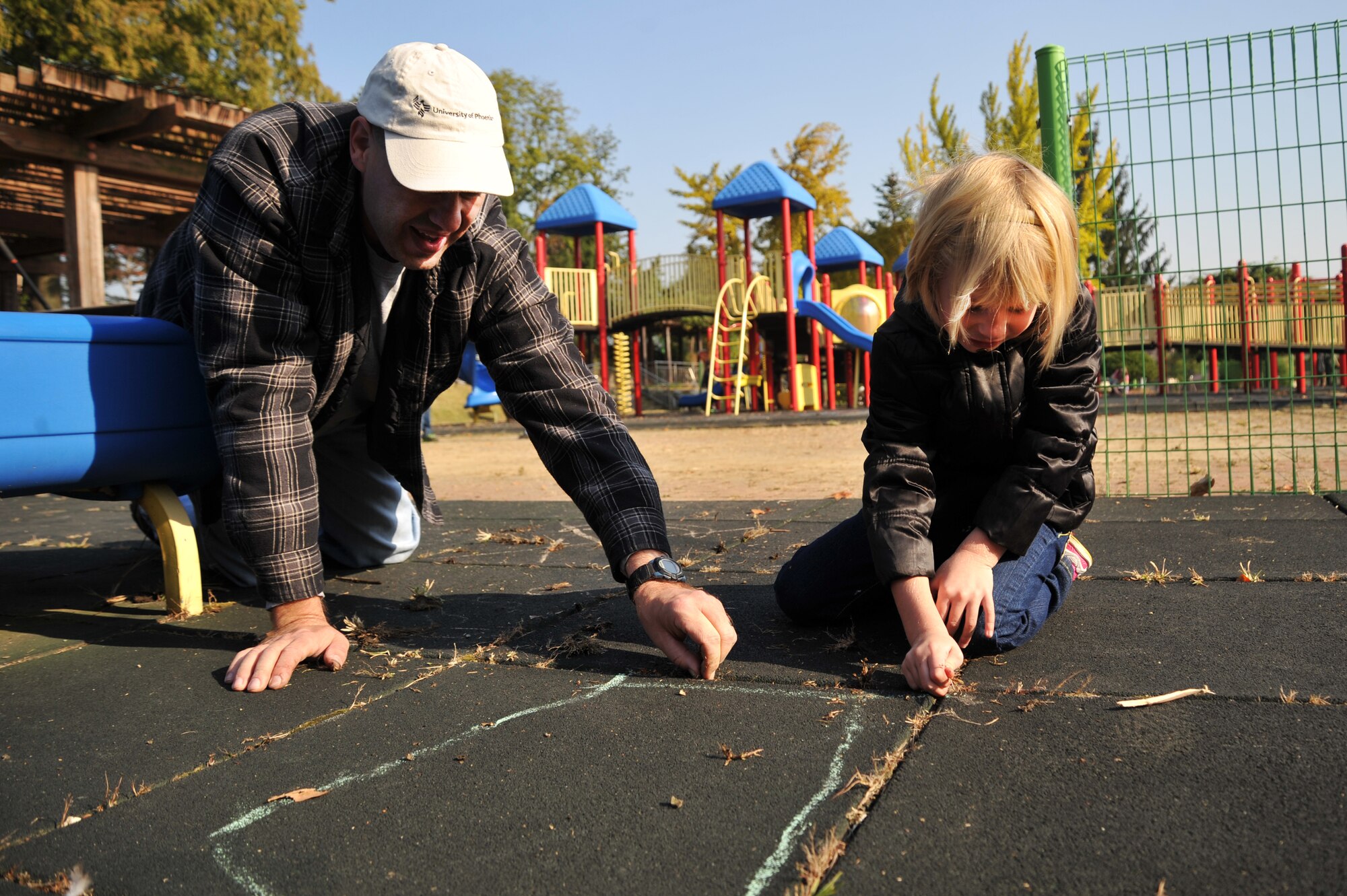 Senior Master Sgt. Lee Schmidt, 51st Munitions Squadron first sergeant and Emily Honaker, 7, help clean up Mustang Valley Park at Osan Air Base, Republic of Korea, Oct. 26, 2013. The Osan Top III council, 51st Civil Engineer Squadron and Osan Boy Scout Troop 86 with Webelos II scouts teamed up for this volunteer project for the community’s benefit. (U.S. Air Force photo/Staff Sgt. Emerson Nuñez)
