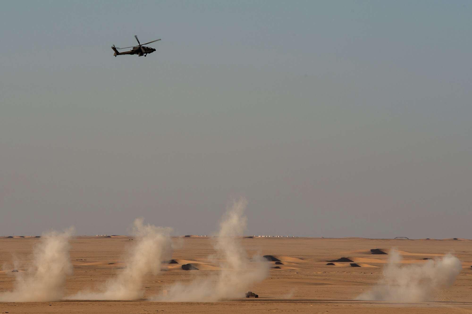 A U.S. Army AH-64 Apache helicopter from the 36th Aviation Brigade banks over smoky remnants of its rocket attack during a joint live-fire exercise Oct. 23, 2013, at a regional range in Southwest Asia. Joint terminal attack controllers from the 82nd Expeditionary Air Support Operations Squadron mentored Army soldiers in coordinating close air support with various types of aircraft and weapons. (U.S. Air Force Photo/Master Sgt. Ben Bloker)