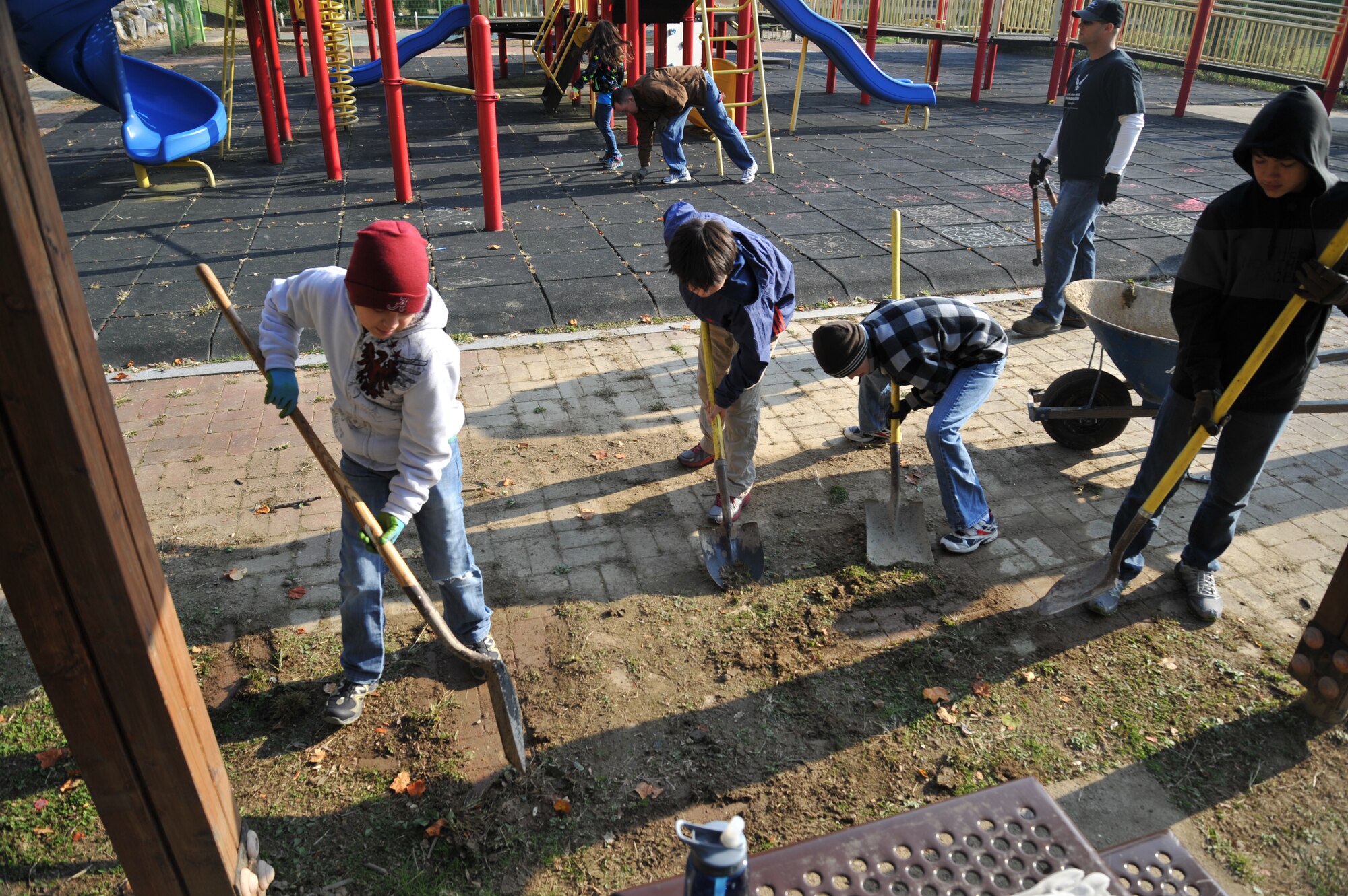Boy Scout Troop 86 help remove dirt and grass the brick floor at Mustang Valley Park at Osan Air Base, Republic of Korea, Oct. 26, 2013. The Osan Top III council, 51st Civil Engineer Squadron and Osan Boy Scout Troop 86 with Webelos II scouts combined forces to renovate the park. (U.S. Air Force photo/Staff Sgt. Emerson Nuñez)
