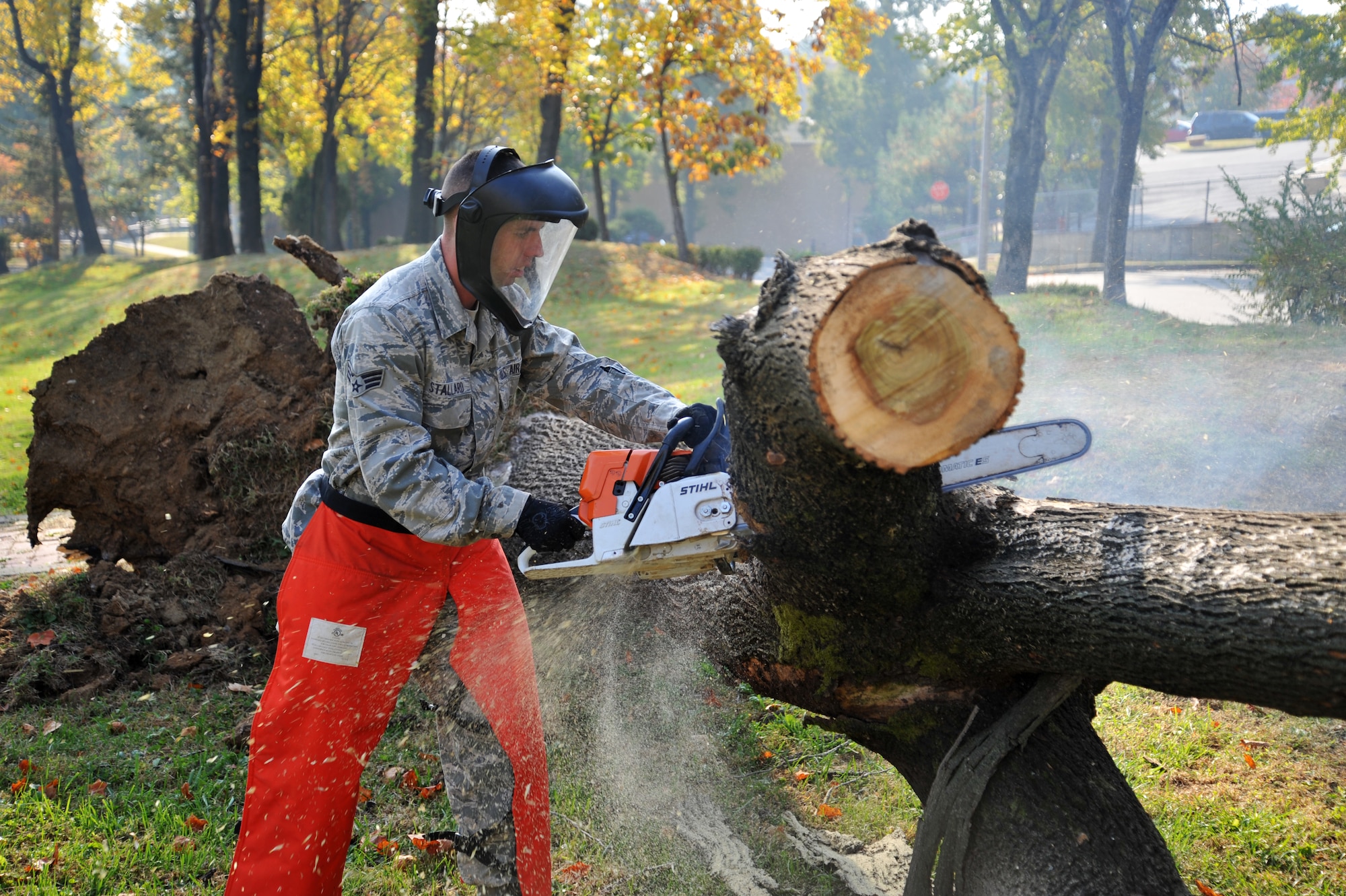 Senior Airman Tres Stallard, 51st Civil Engineer Squadron heavy equipment operator, takes apart a tree limb at Mustang Valley Park at Osan Air Base, Republic of Korea, Oct. 26, 2013. In order to maintain the park’s cleanliness, the groups plan on seasonal cleaning when the leaves fall and at the beginning of spring. (U.S. Air Force photo/Staff Sgt. Emerson Nuñez)