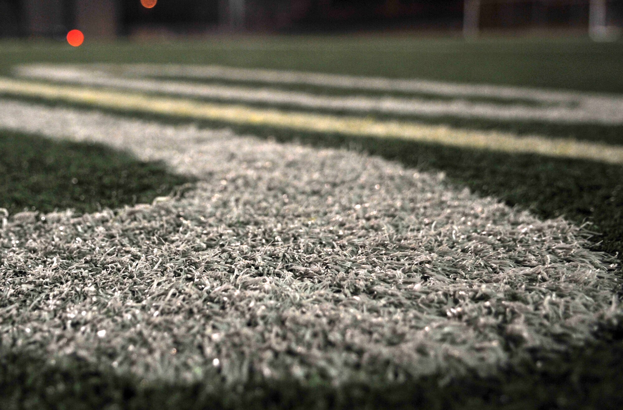 The 50-yard line on the Osan High School football field was the gathering place for approximately 25 people during a Breast Cancer and Domestic Violence Awareness Month candlelight vigil at Osan Air Base, Republic of Korea, Oct. 26, 2013. The vigil was a final tribute to those who have overcome, or succumbed to, breast cancer or domestic violence. (U.S. Air Force photo/Airman 1st Class Ashley J. Thum)