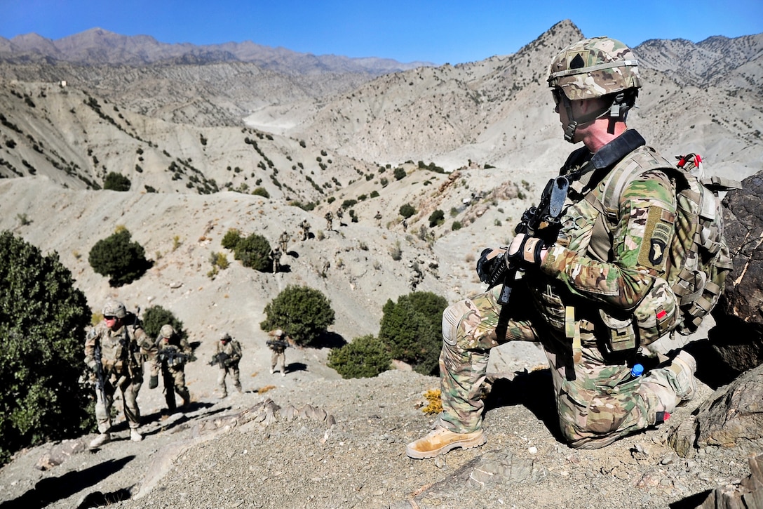 U.S. Army Pfc. Travis McGehee, right foreground, provides security as his fellow soldiers walk up a mountain trail during a patrol with Afghan soldiers in Afghanistan's Paktia province, Oct. 21, 2013. McGehee, an infantryman, is assigned to the 101st Airborne Division's 1st Battalion, 506th Infantry Regiment , 4th Brigade Combat Team.
