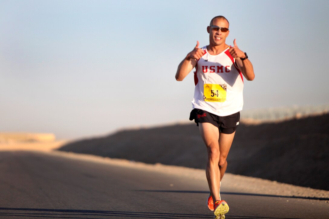 U.S. Marine Corps Capt. Pedro Rodriguez gives two thumbs up while running the 26.2-mile course for the Marine Corps Marathon Forward on Camp Leatherneck in Afghanistan's Helmand province, Oct. 27, 2013.