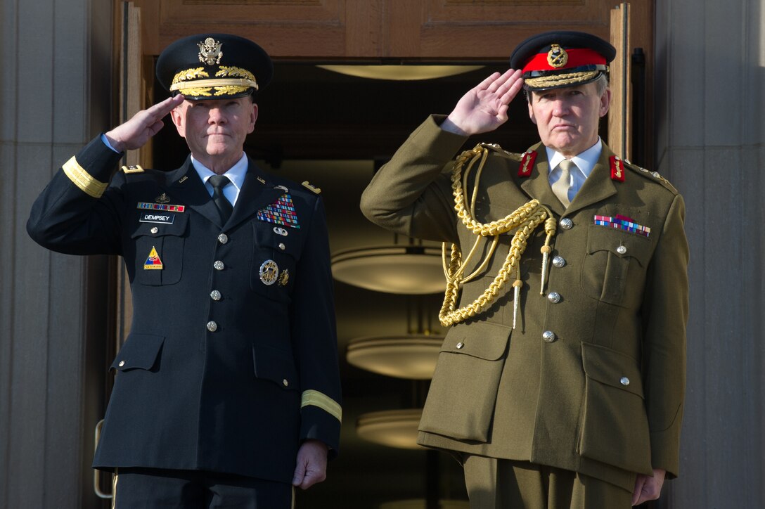U.S. Army Gen. Martin E. Dempsey, left, chairman of the Joint Chiefs of Staff, and British Army Gen. Nicholas Houghton, chief of Britain's defense staff, salute during an honor cordon at the Pentagon, Oct. 28, 2013.