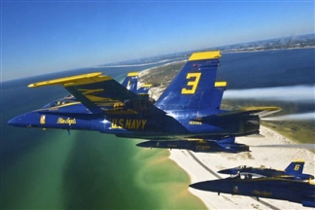 Pilots of the U.S. Navy’s Blue Angels fly in a delta formation during a training flight over the beaches of Pensacola, Fla., on Oct. 23, 2013.  Members of the Navy Flight Demonstration Squadron maintained minimum safe flying levels and proficiency flight operations during cancellation of the 2013 Blue Angels performances.  This month, the Department of Defense approved funding for the Blue Angels full 2014 air show season.  