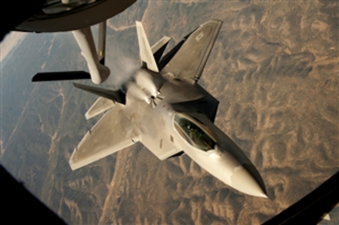 A U.S. Air Force F-22 Raptor backs away from a KC-135 Stratotanker after conducting an in-flight refueling during a training mission over central New Mexico on Oct. 23, 2013.  The Raptor is assigned to the 49th Fighter Wing at Holloman Air Force Base, N.M.  The Stratotanker is assigned to McConnell Air Force Base, Kan.  