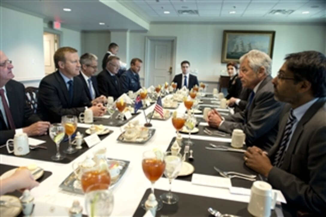 Secretary of Defense Chuck Hagel, second from right, meets with New Zealand Minister of Defense Jonathan Coleman, second from left, in the Pentagon in Arlington, Va., on Oct. 28, 2013.  Hagel and Coleman are meeting to discuss national and regional security items of interest to both nations.  