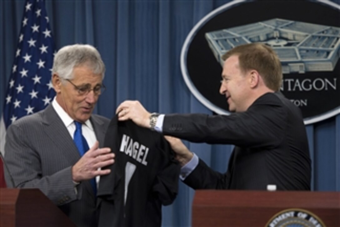 New Zealand Minister of Defense Jonathan Coleman, right, presents Secretary of Defense Chuck Hagel with a jersey from New Zealand’s national rugby team, the All Blacks during a joint press conference in the Pentagon in Arlington, Va., on Oct. 28, 2013. Coleman and Hagel met earlier to discuss national and regional security items of interest to both nations.  