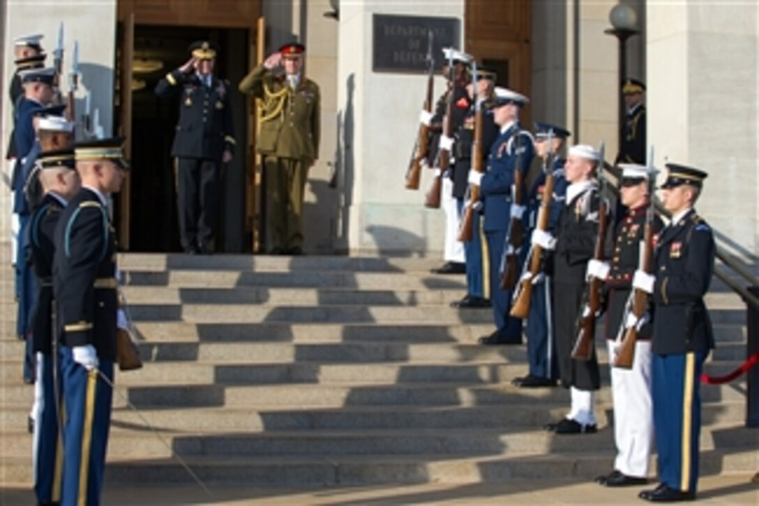 Chairman of the Joint Chiefs of Staff Gen. Martin E. Dempsey, left, and United Kingdom Chief of Defense Staff Gen. Sir Nicholas Houghton salute during an honor cordon on the steps of the Pentagon in Arlington, Va., on Oct. 28, 2013.  
