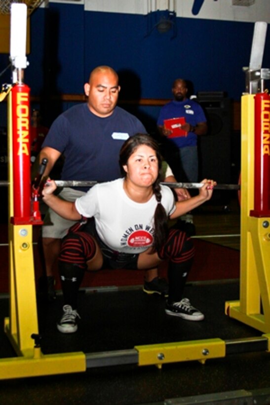 Nancy Rodriguez, the 148-pound female division second place winner, squats 176 pounds during the Far East Powerlifting Championship Competition at the IronWorks Gym sports courts here Aug. 12, 2012. Rodriguez lifted a total combined weight of 491 pounds in the squat, bench press and deadlift events.