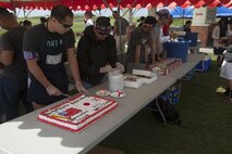 Volunteers with the Camp Kinser USO serve cake Oct. 26 following a softball game between the Urasoe and 3rd Marine Logistics Group teams. The luncheon after the game was sponsored in part by Marine Corps Community Services and the USO. The event was a way to continue building relationships between local community members and Okinawa-based service members and their families. 3rd MLG is a part of III Marine Expeditionary Force. 