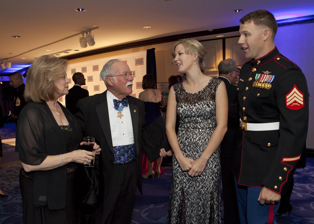 From the left, Mrs. Barnum; retired Marine Corps Col. Harvey Barnum; Mrs. Seif; and Sgt. Andrew C. Seif, speak together during the reception before the 2013 USO Gala in Washington, D.C. on Oct. 25, 2013. The Assistant Commandant of the Marine Corps, Gen. John M. Paxton, Jr., not shown, presented Sgt. Seif with the USO Marine of the Year award during the event. (U.S. Marine Corps photo by Cpl. Tia Dufour/Released)