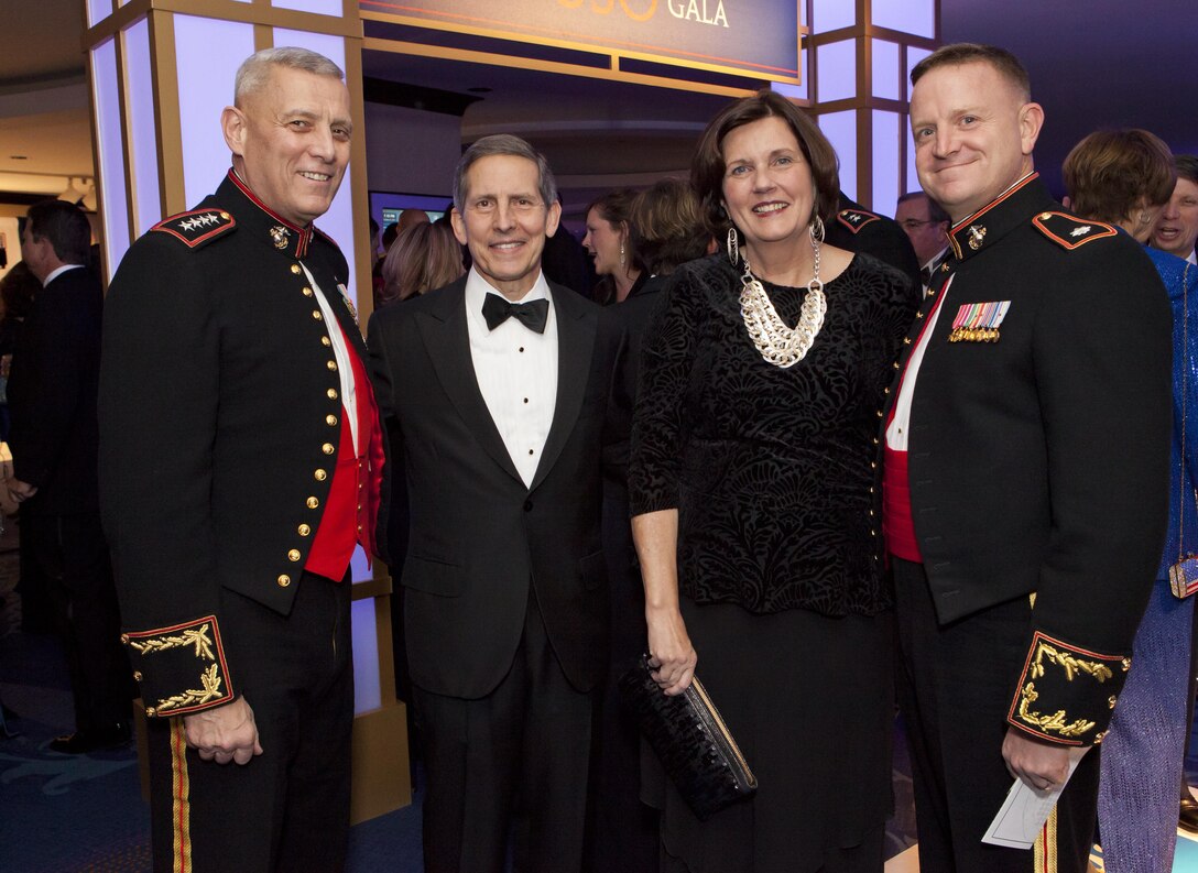 From the left, the Assistant Commandant of the Marine Corps, Gen. John M. Paxton, Jr.; USO President and CEO, Sloan D. Gibson; Debbie Paxton; and a Marine major pose for a photo during the reception before the 2013 USO Gala in Washington, D.C., Oct. 25, 2013. Gen. Paxton presented the USO Marine of the Year award to Sgt. Andrew C. Seif, not shown, during the event. (U.S. Marine Corps photo by Cpl. Tia Dufour/Released)