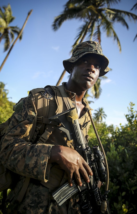 Corporal Stephen Fisher of Hurt, Va., provides security during a training scenario October 18, 2013.  The fire team leader with Africa Partnership Station 13, along with the rest of the unit, participated in a training exercise focusing on riot control, riverine operations, ambush reaction drills and more. Each exercise, led by British Marine forces, challenged the Marines through different scenarios focusing on all aspects of military tactics. APS is an international security cooperation initiative, facilitated by U.S. Naval Forces Africa and Marine Corps Forces Africa, aimed at strengthening global maritime partnerships through training and collaborative activities in order to improve maritime safety and security in Africa. 