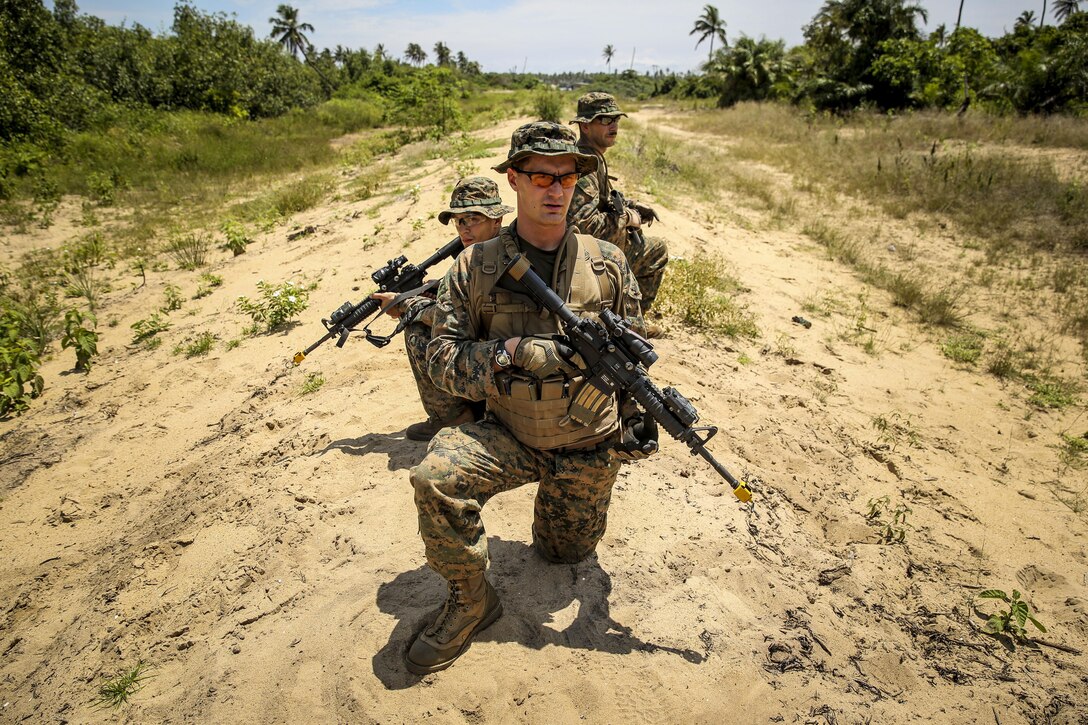 Sergeant Joseph Moyer (front) of Pottsville, Pa., observes his squad during an assault on an enemy ambush October 18, 2013.  The squad leader with Africa Partnership Station 13, along with the rest of the unit, participated in a training exercise focusing on riot control, riverine operations, ambush reaction drills and more. Each exercise, led by British Marine forces, challenged the Marines through different scenarios focusing on all aspects of military tactics.  APS is an international security cooperation initiative, facilitated by U.S. Naval Forces Africa and Marine Corps Forces Africa, aimed at strengthening global maritime partnerships through training and collaborative activities in order to improve maritime safety and security in Africa. 