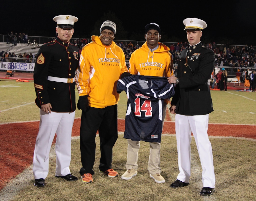 Marines of Recruiting Station Nashville present a Semper Fidelis All-American Bowl jersey to high school senior Rashaan Gaulden during halftime of a local football game in Murfreesboro, Tenn., October 24, 2013. Gaulden, who has committed to the University of Tennessee was selected to participate in the Semper Fidelis All-American Bowl in January in Carson, Calif. Gaulden plays safety on the Independence High School varsity football team.
