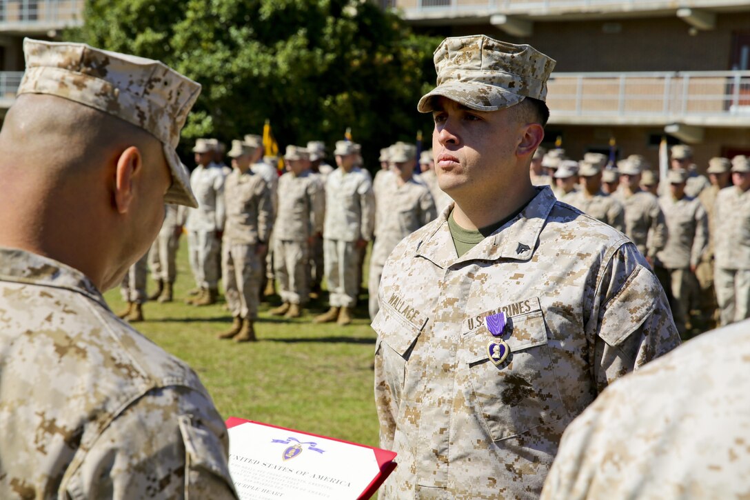 Cpl. Richard Wallace, a team leader with Fox Company, 2nd Battalion, 2nd Marine Regiment and Chicago native, receives his Purple Heart Medal for wounds received in Afghanistan in support of Operation Enduring Freedom Oct. 24, 2013.  (Official U.S. Marine Corps photo by Lance Cpl. Michael C. Dye)