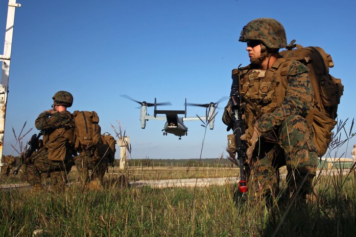 U.S. Marines with Special-Purpose Marine Air-Ground Task Force Crisis Response hold security while an MV-22B Osprey takes off from Camp des Garrigues, France, Oct. 28, 2013, during bilateral training between SP-MAGTF Crisis Response and French Legionnaires from the 2nd Foreign Infantry Regiment of the 6th Light Armored Brigade. The aircraft, attached to SP-MAGTF Crisis Response from Marine Medium Tiltrotor Squadron 162, was the first MV-22B Osprey to ever land in France. SP-MAGTF Crisis Response is a self-mobile, self-sustaining force capable of responding to a range of crises in the U.S. Africa Command area of responsibility to protect U.S. and partner-nation interests. They also conduct military-to-military training exercises with partner nations throughout U.S. Africa Command and U.S. European command. (U.S. Marine Corps photo by Cpl. Michael Petersheim)