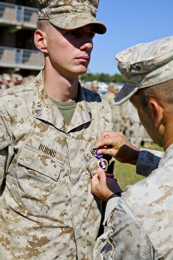 MARINE CORPS BASE CAMP LEJEUNE, N.C. – Cpl. Jerry Burns, a team leader with Fox Company, 2nd Battalion, 2nd Marine Regiment and Ocala, Fla. native, receives his Purple Heart Medal for wounds received in Afghanistan in support of Operation Enduring Freedom Oct. 24, 2013.  (Official U.S. Marine Corps photo by Lance Cpl. Michael C. Dye)