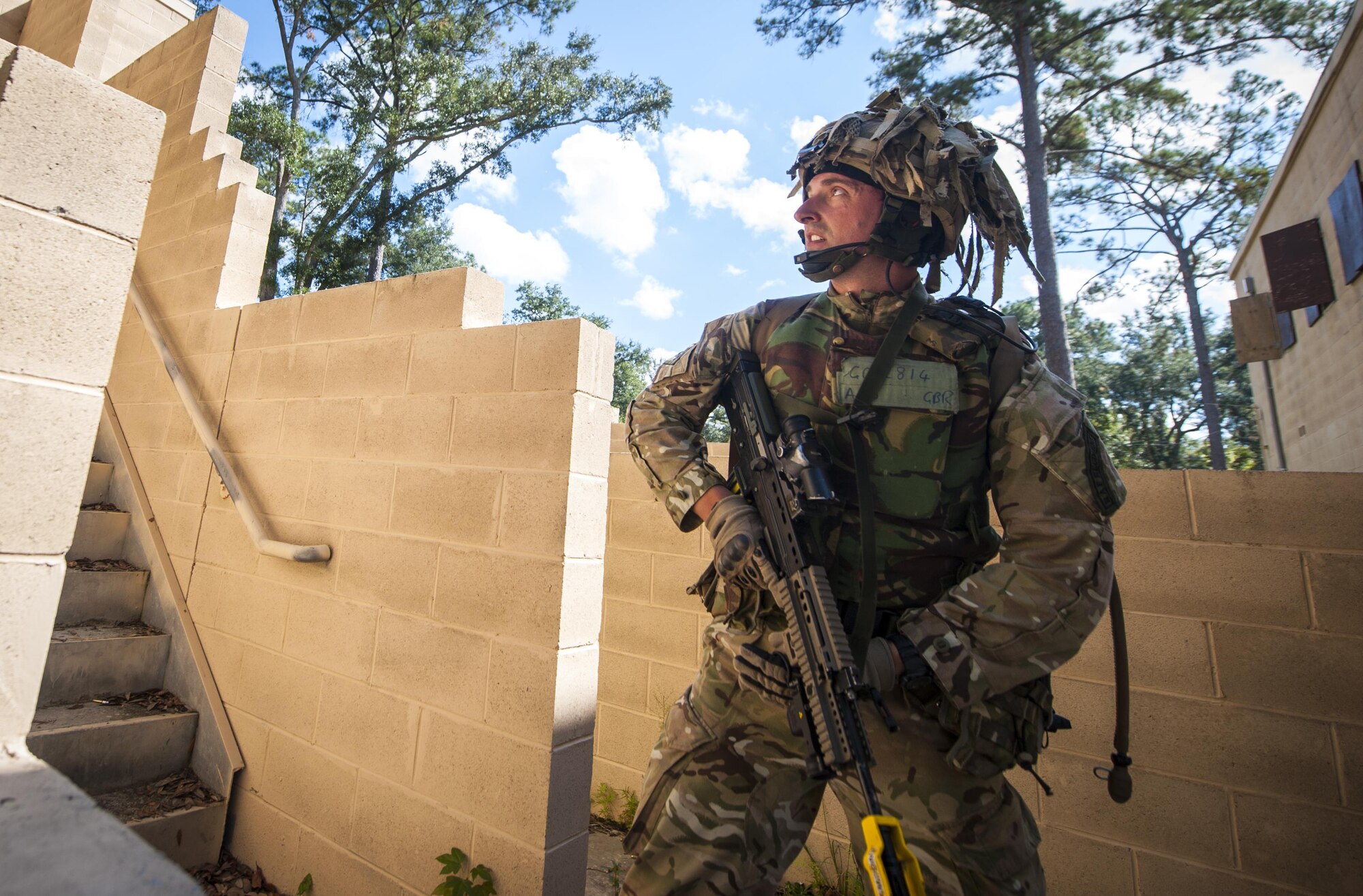 Royal Air Force Lance Cpl. Michael Gold communicates with his teammates during Exercise Global Eagle Oct. 17, 2013, at Moody Air Force Base, Ga. Every year, RAF Regiment and 820th Base Defense Group defenders train together to exchange tactics, techniques and procedures. Gold is assigned to the No. 1 Squadron RAF Regiment. 