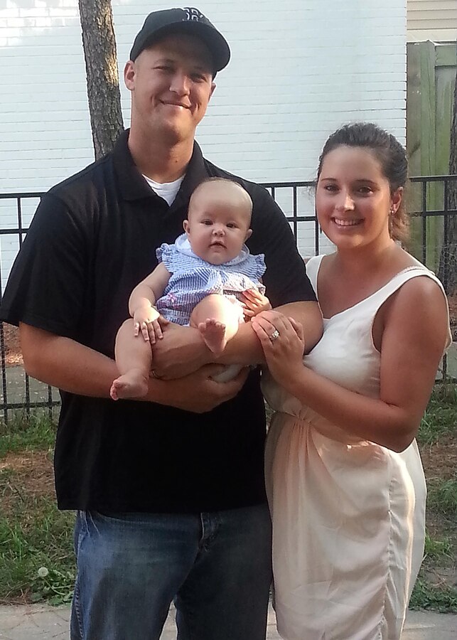 NORFOLK, Va. (Oct. 29, 2013) - Sgt. Matthew Sweigert poses for a picture with his wife Isabella and daughter Haley. The Sweigert family was selected as the Marine Military Family of the Year 2013. Over the course of the year, Sweigert coached the Tigers baseball team, in the 757 wooden bat leagues from a 4-20 record last year to 16-8 in 2013. He also volunteered for the Headquarters and Service Battalion's color guard team, performing in numerous ceremonies for the community and military events. Sweigert also shows his dedication to fellow Marines by maintaining his certification as a Never Leave a Marine Behind suicide prevention team instructor since 2012. Outside of his military duties, he has maintained a 3.75 grade point average working towards his degree in Social and Criminal Justice through Ashford University, recently making the dean's list for academic excellence.