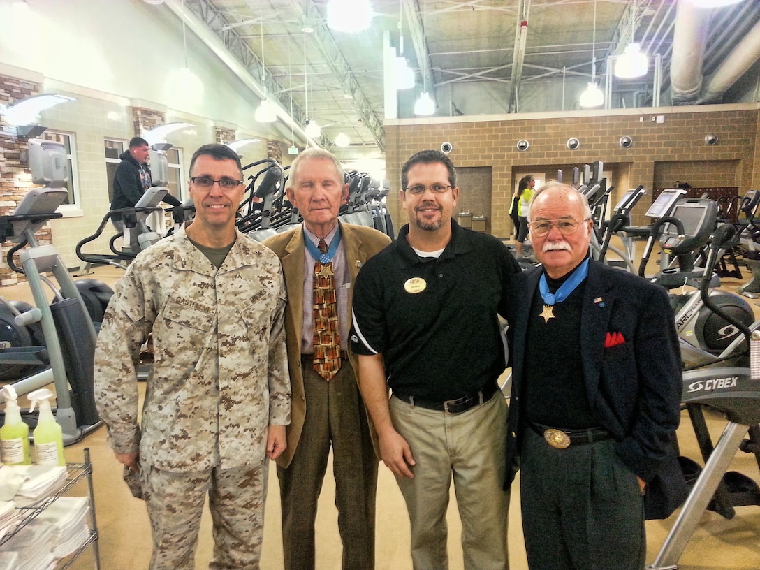 (From Left to Right) MCIEAST-MCB Camp Lejeune Commanding General Brig. Gen. Robert F. Castellvi, Congressional Medal of Honor recipients Maj. Gen. James E. Livingston, (USMC, ret.) and Col. Harvey "Barney" Barnum, Jr. (USMC, ret.) (far right), and Wallace Creek Fitness Center manager Brian Crawford pose for a picture during a tour of the center Tuesday, Oct. 29, 2013. The Medal of Honor recipients are here aboard the base for two days giving warrior talks to Marine units and their spouses.