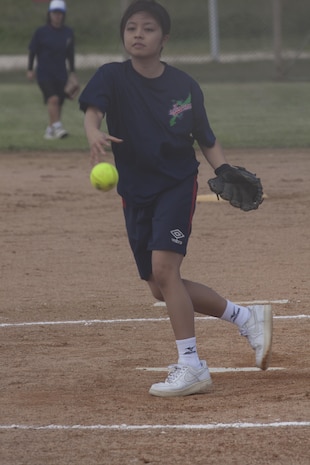 Senri Shimabukuro pitches Oct. 26 during a softball game between Ryukyu Ruckus and Team Urasoe at Camp Kinser. Both sides enjoyed the opportunity to play each other, according to Jamie Emery, head coach for the Ruckus. “We see the dedication and love (Urasoe) have for the game, and admire that very much,” said Emery. Ryukyu Ruckus is a team comprised of players from 3rd Marine Logistics Group, III Marine Expeditionary Force.  