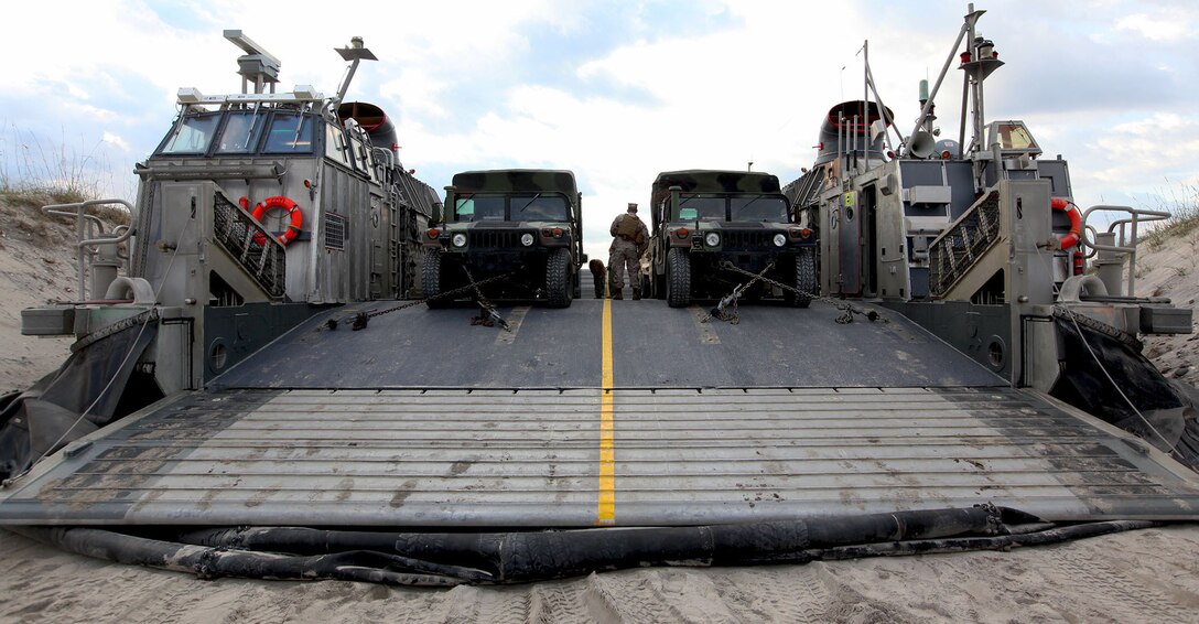 Two U.S. Marine Corps Humvees are strapped down to the deck of a U.S. Navy landing craft, air cushion during a movement of the 22nd Marine Expeditionary Unit's (MEU) equipment at Marine Corps Base Camp Lejeune, N.C., Oct. 25, 2013. The 22nd MEU and Bataan Amphibious Ready Group (ARG) are conducting the ARG/MEU Exercise, or ARG/MEU Ex, off the East Coast through mid-November. The MEU is scheduled to deploy in early 2014 to the U.S. 5th and 6th Fleet areas of responsibility with the Bataan ARG as a sea-based, expeditionary crisis response force capable of conducting amphibious missions across the full range of military operations. (U.S. Marine Corps photo by Lance Cpl. Caleb McDonald/Released)