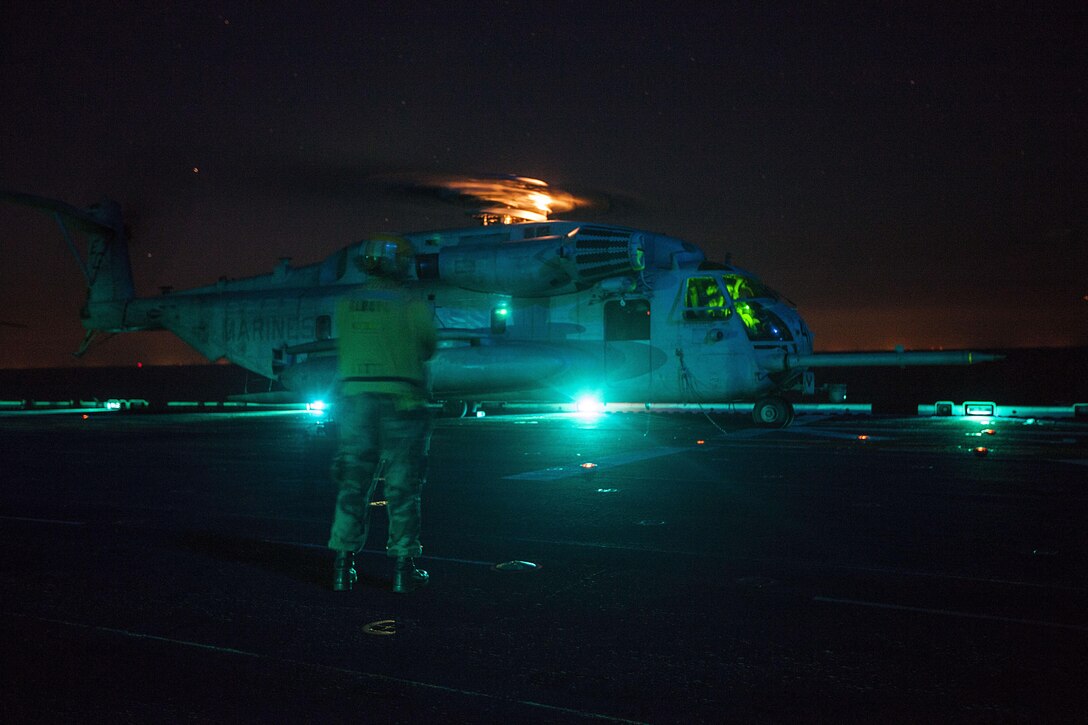 A CH-53E Super Stallion helicopter with the 22nd Marine Expeditionary Unit (MEU) prepares for takeoff aboard the USS Bataan (LHD 5) off the East Coast during a reconnaissance and surveillance exercise Oct. 27, 2013. The MEU is currently taking part in the Amphibious Ready Group/MEU Exercise in preparation for its scheduled 2014 deployment to the U.S. 5th and 6th Fleet areas of responsibility with the Bataan Amphibious Ready Group as a sea-based, expeditionary crisis response force capable of conducting amphibious missions across the full range of military operations. (U.S. Marine Corps photo by Sgt. Austin Hazard/Released)