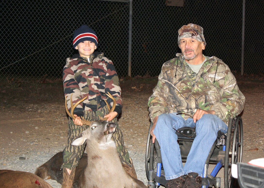 Ricky Pless, a member of the Paralyzed Veterans of America Southeast chapeter, and his grandson Landon pose with a deer harvested at the U.S. Army Corps of Engineers Richard B. Russell Lake, Oct. 23, 2013.