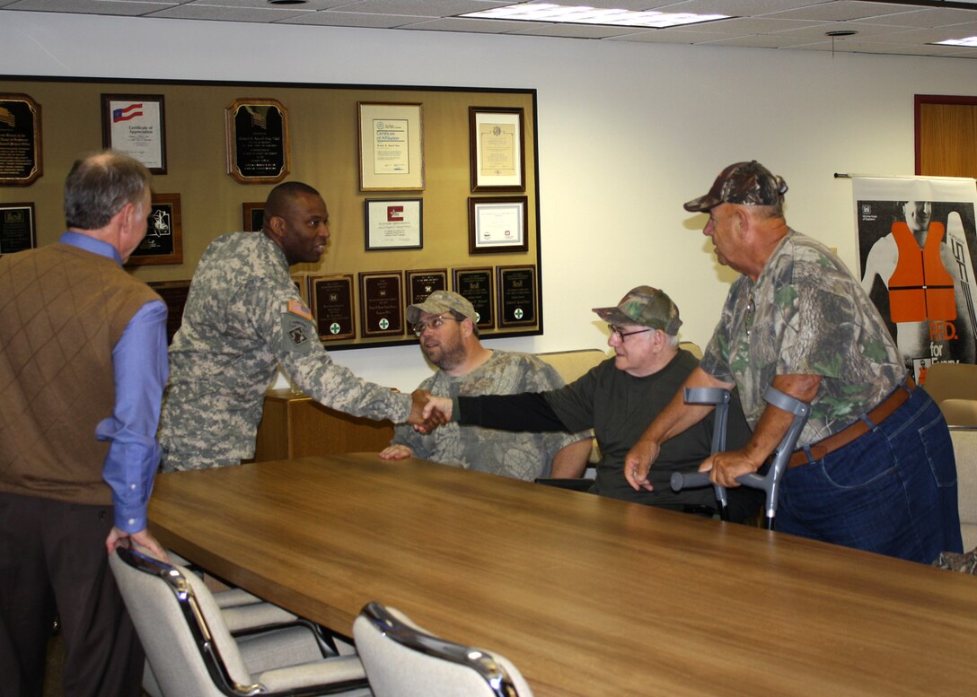 USACE South Atlantic Division Command Sgt. Maj. Antonio Jones shakes hands with members of the Paralyzed Veterans of America Southeastern chapter at Richard B. Russell Lake, Oct. 23, 2013.