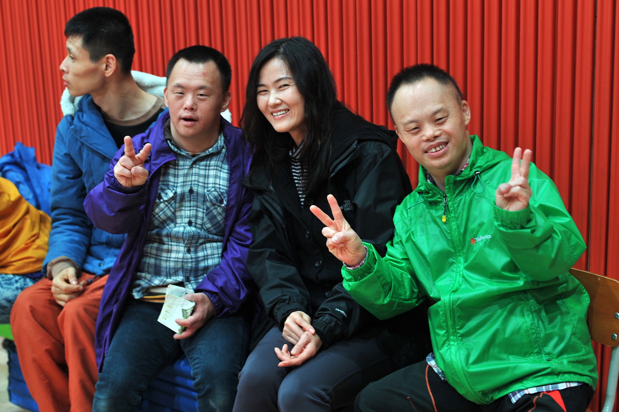 Yu Cho, middle right, 51st Comptroller Squadron financial management assistant, sits with two residents of the Seongsimdongwon Group Home for the disabled in Osan City, Republic of Korea, Oct. 27, 2013. The Osan Air Base Company Grade Officer’s Council and members of the 51st Fighter Wing Staff Agencies plan on making future trips to the home to visit and help with lunch every other month. (U.S. Air Force photo/Staff Sgt. Emerson Nuñez)