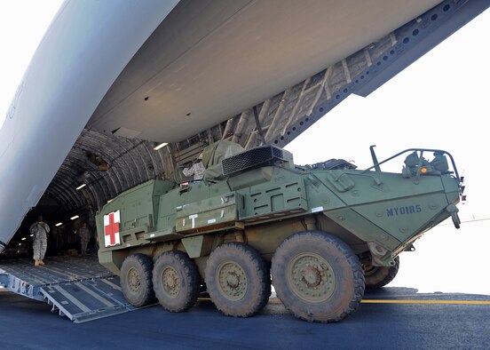 U.S. Army 1-14 Infantry Battalion Soldiers assigned to the 2nd Stryker Brigade Combat Team prepare to load a Stryker Medical Evacuation Vehicle aboard a C-17 Globemaster III during a validation exercise on the flightline at Joint Base Pearl Harbor Hickam, Hawaii, Oct. 17, 2013. The exercise was the first of its kind, and verified the JBPPH C-17s assigned to the 535th Airlift Squadron could load and transport the combat vehicles and crew.  (U.S. Air Force photo/Tech. Sgt. Jerome S. Tayborn)