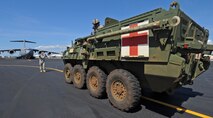 U.S. Army Sgt. 1st Class Eric Pettengill, 380th Ground Liaison Detachment, guides a Stryker driver and crew assigned to the 1-14 Infantry Battalion 2nd Stryker Brigade Combat Team aboard a C-17 Globemaster III during a validation exercise on the flightline at Joint Base Pearl Harbor Hickam, Hawaii, Oct. 17, 2013.  The MEV is the Battalion Aid Station for brigade units, providing treatment for serious injury and advanced trauma cases. (U.S. Air Force photo/Tech. Sgt. Jerome S. Tayborn)