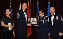 U.S. Air Force Senior Airman Krystine Zuest, instrument and flight control journeymen from the 718th Aircraft Maintenance Squadron, receives the John L. Levitow Award during her Airman Leadership School graduation on Kadena Air Base, Japan, Oct. 24, 2013. This award, which is named after the Medal of Honor recipient John L. Levitow, recognized Zuest as the top of her class in a combined role as a leader and scholar. (U.S. Air Force photo by Airman 1st Class Keith James)