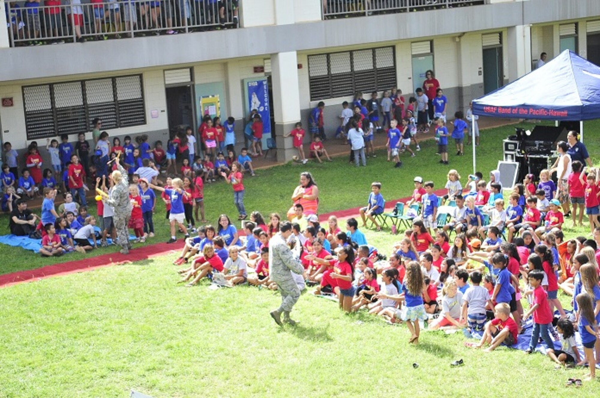 WAILUA, Hawaii -- The Band of the Pacific-Hawaii's rock band, Hana Hou, performed for a thousand elementary children at Wailua Elementary, October 22, 2013. Vocalists SSgt Courtney Clifford and SrA Devin Rivas-Martin hand out percussion instruments to the children, inviting them to play along.The performance was part of a community relations outreach initiative, supporting in part the Red Ribbon Week anti-drug initiative. (US Air Force Photo/TSgt Ben Kadow/released)