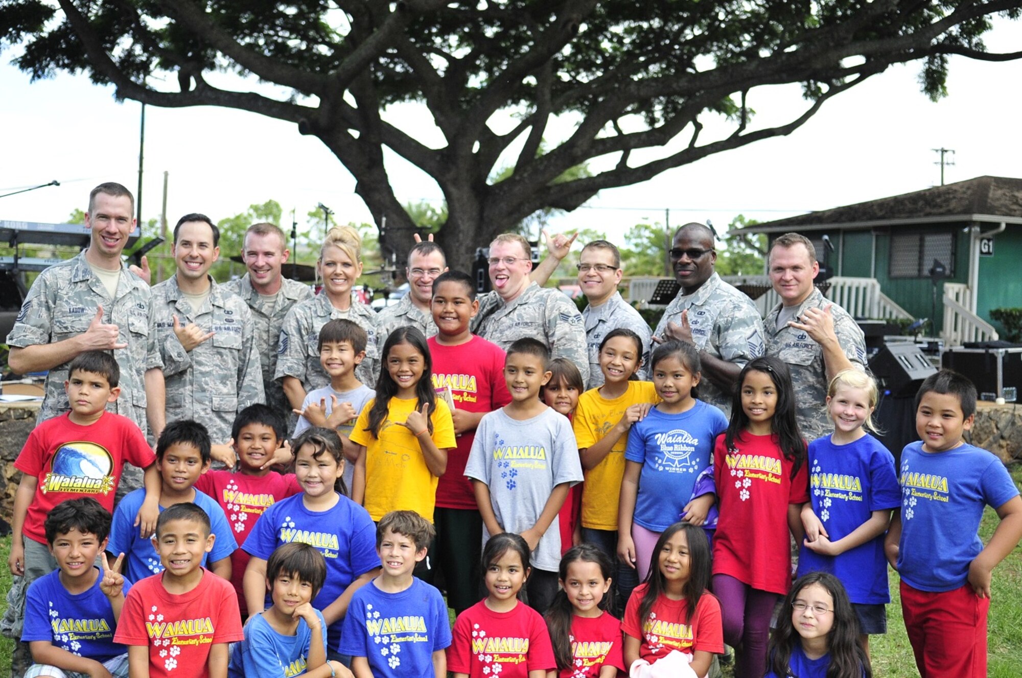 WAILUA, Hawaii -- The Band of the Pacific-Hawaii's rock band, Hana Hou, performed for a thousand elementary children at Wailua Elementary, October 22, 2013. Hana Hou poses with some of the students.The performance was part of a community relations outreach initiative, supporting in part the Red Ribbon Week anti-drug initiative. (US Air Force Photo/SSgt Courtney Clifford/released)