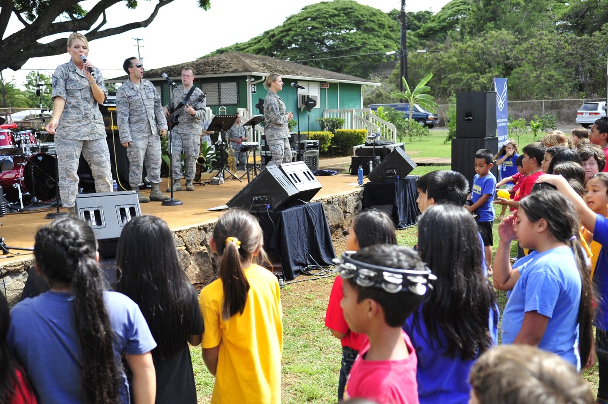 WAILUA, Hawaii -- The Band of the Pacific-Hawaii's rock band, Hana Hou, performed for a thousand elementary children at Wailua Elementary, October 22, 2013. Hundreds of children rushed to the stage to help play percussion and sing.The performance was part of a community relations outreach initiative, supporting in part the Red Ribbon Week anti-drug initiative. (US Air Force Photo/TSgt Ben Kadow/released)