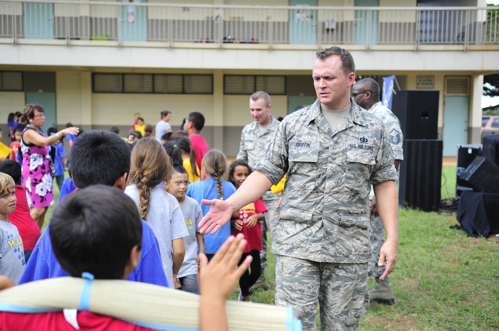 WAILUA, Hawaii -- The Band of the Pacific-Hawaii's rock band, Hana Hou, performed for a thousand elementary children at Wailua Elementary, October 22, 2013. SSgt Troy Griffin, Band of the Pacific-Hawaii drummer, gave high-five to students after the show. The performance was part of a community relations outreach initiative, supporting in part the Red Ribbon Week anti-drug initiative. (US Air Force Photo/SSgt Courtney Clifford/released)