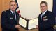 New York Air National Guard Maj. David Pyke (right) receives a Certificate of Retirement from Lt. Col. Charles Hutson, Commander of the 174th Comptroller Flight on 4 October 2013 during a retirement ceremony held at Hancock Field Air National Guard Base, Syracuse, New York. Maj. Pyke also received a Meritorious Service Medal during the ceremony. Maj. Pyke joined the unit in April of 1990. (New York Air National Guard Photo by Senior Airman Duane Morgan)