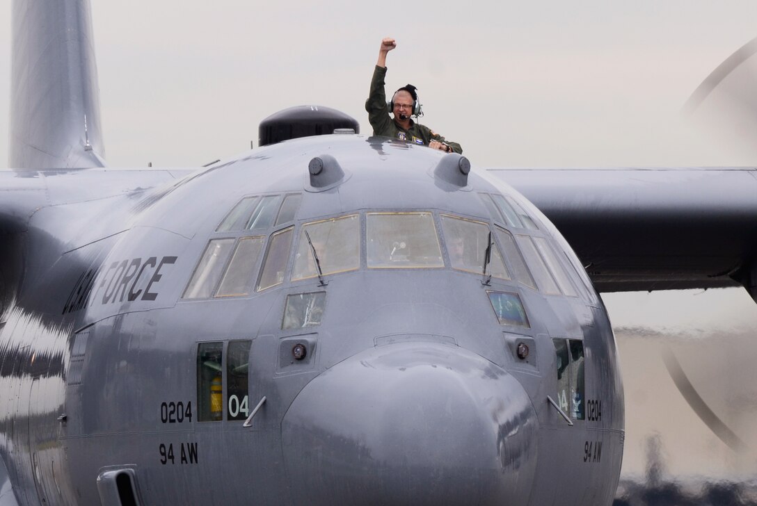 Col. Tim E. Tarchick, 94th Airlift Wing, commander enthusiastically greets a crowd of well- wishers during the final leg of his finiflight on Dobbins Air Reserve Base, Ga. Oct. 28. Tarchick retires after 35.5 years of successful service. (U.S. Air Force photo/Don Peek)