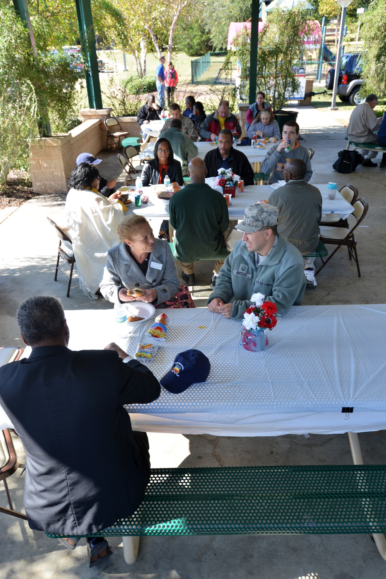 Participants of the 14th Annual Ability One Appreciation Picnic sit and eat a free lunch, Shaw Air Force Base S.C., Oct. 25, 2013. The annual picnic, hosted by the 20th Contracting Squadron, provided free food for about 175 individuals as a way of thanking them for their support to Team Shaw. (U.S. Air Force photo by Airman 1st Class Jensen Stidham/Released)