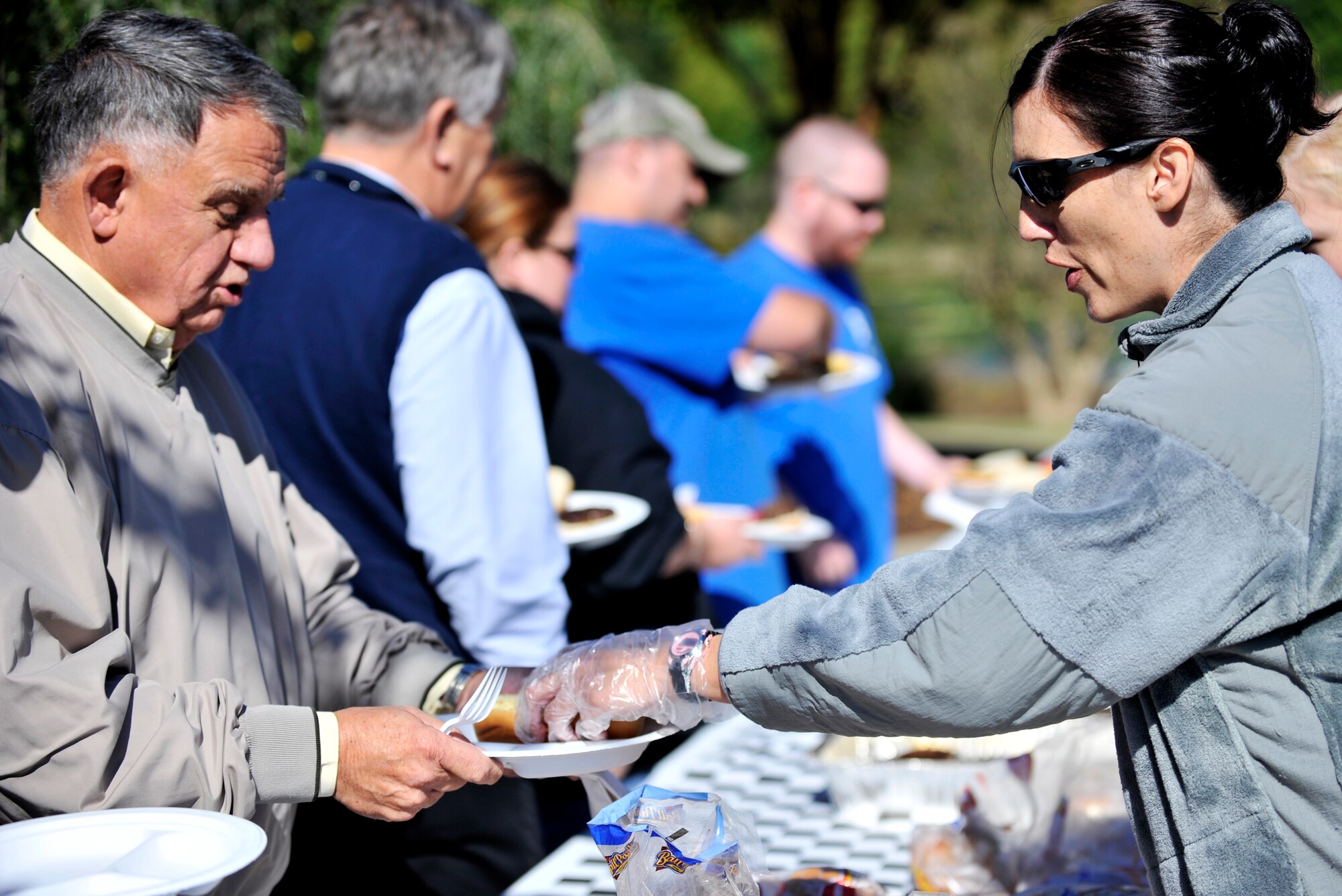 U.S. Air Force Master Sgt. Lisa Wright, 20th Contracting Squadron superintendent, serves food during the 14th Annual Ability One Appreciation Picnic, Shaw Air Force Base S.C., Oct. 25, 2013. The annual picnic, hosted by the 20th Contracting Squadron, was a way of saying “thanks” to the Ability One Program a federal initiative which provides jobs for people with disabilities on military installations throughout the country. (U.S. Air Force photo by Airman 1st Class Jensen Stidham/Released)