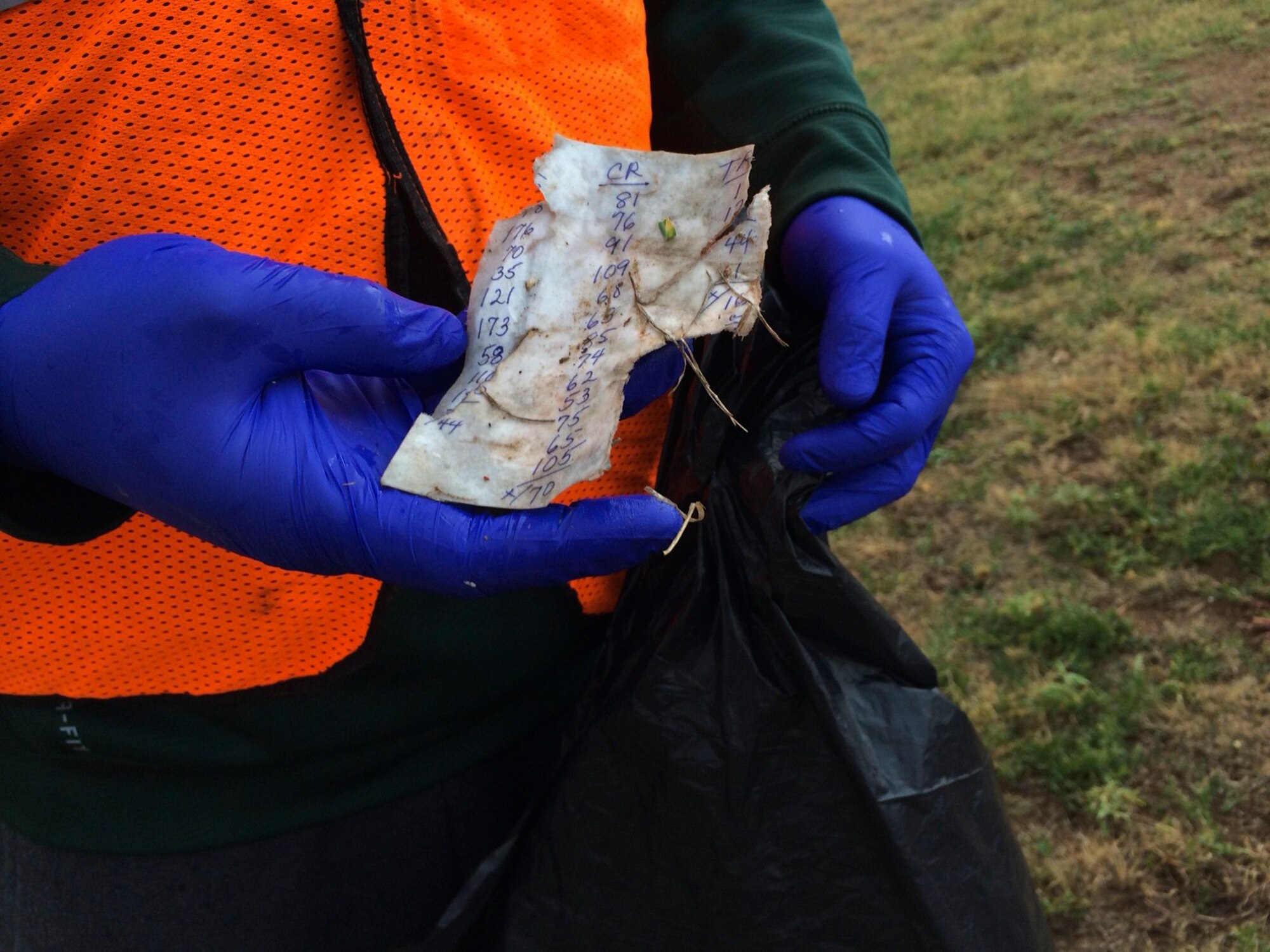 ALTUS AIR FORCE BASE, Okla. – U.S. Air Force Airman 1st Class Jacob Engle, a student from the 97th Training Squadron, holds a piece of trash outside of Altus AFB Oct. 26, 2013. Volunteers walked along Veterans Drive and picked up trash. (U.S. Air Force photo by Staff Sgt. Nathanael Callon/Released) 