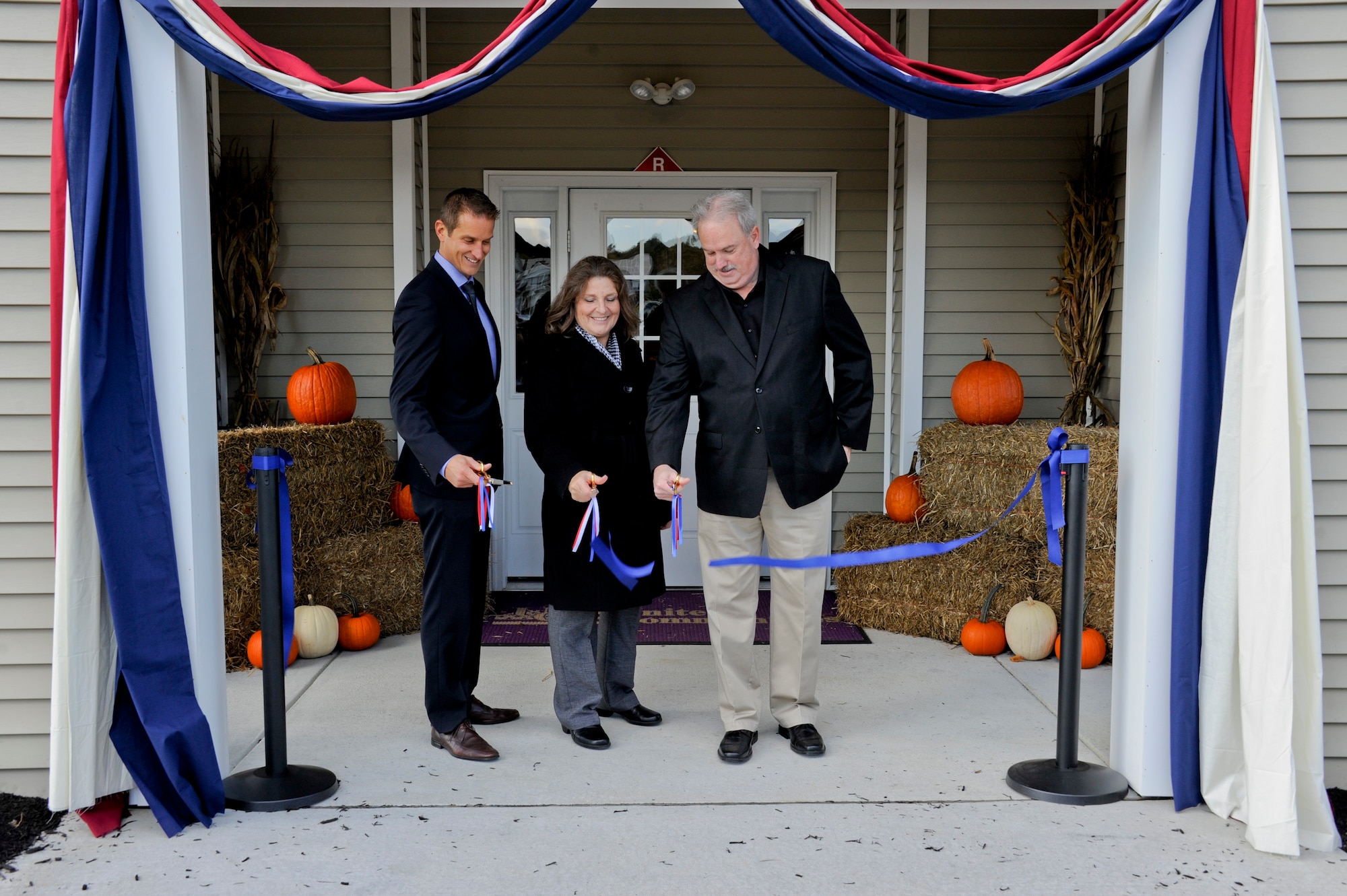 JOINT BASE MCGUIRE-DIX-LAKEHURST, N.J. – Anita Moore, wife of the late Bob Moore, cuts the ribbon to the Robert M. Moore Community Center here. The center will serve as a place for families to gather for fun and friendship, as well as a permanent reminder of the tireless effort and passionate leadership exhibited by the former director of the Air Force Civil Engineer Center's Installations Directorate. (U.S. Ai rForce photo/Airman Tara A. Williamson, Joint Base McGuire-Dix-Lakehurst Public Affairs)