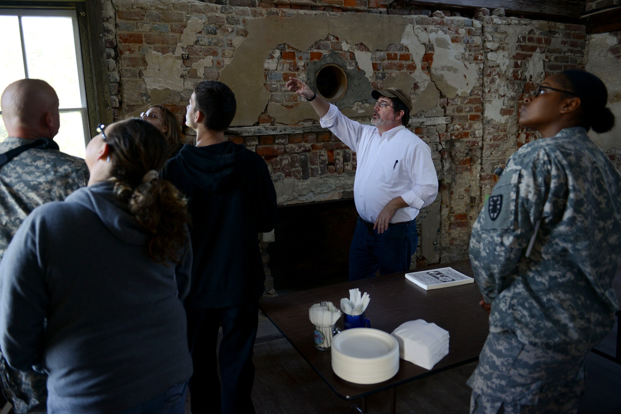 Dr. Christopher McDaid, 733rd Civil Engineer Division cultural resources manager, speaks to visitors about artifacts at the Matthew Jones house at Fort Eustis, Va., Oct. 29, 2013. The 733rd CED hosted an open house in support of National Archaeology Month, and McDaid shared with visitors how they manage, protect and preserve more than 200 archaeological sites on Fort Eustis. (U.S. Air Force photo by Staff Sgt. Ciara Wymbs/Released)