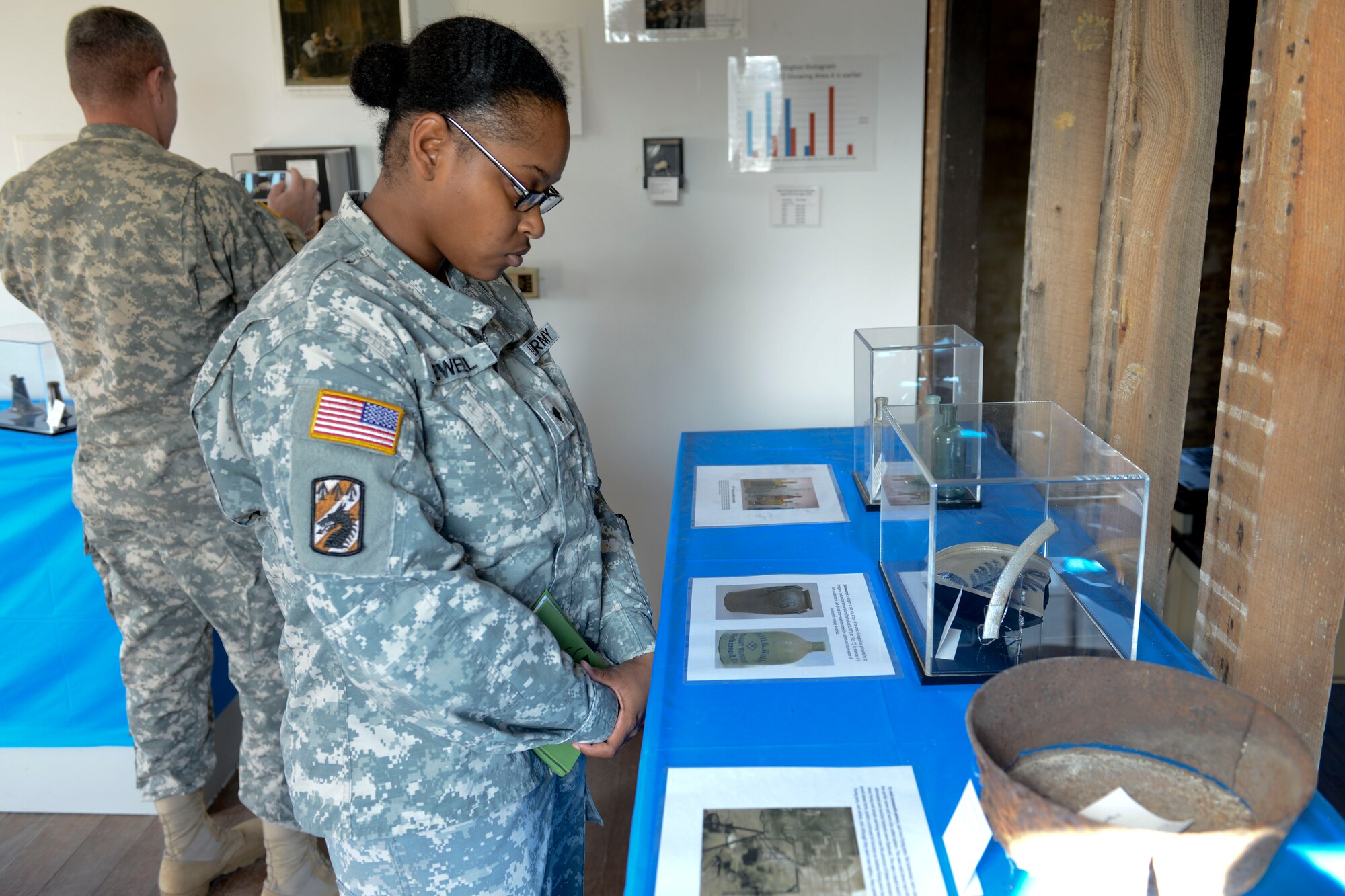U.S. Army Spc. She-ra Newell, 510th Human Resources Company human resources specialist, views artifacts during the 733rd Civil Engineer Division’s National Archaeology Month open house at the Matthew Jones House at Fort Eustis, Va., Oct. 29, 2013. There are more than 200 archaeological sites on Fort Eustis. (U.S. Air Force photo by Staff Sgt. Ciara Wymbs/Released)