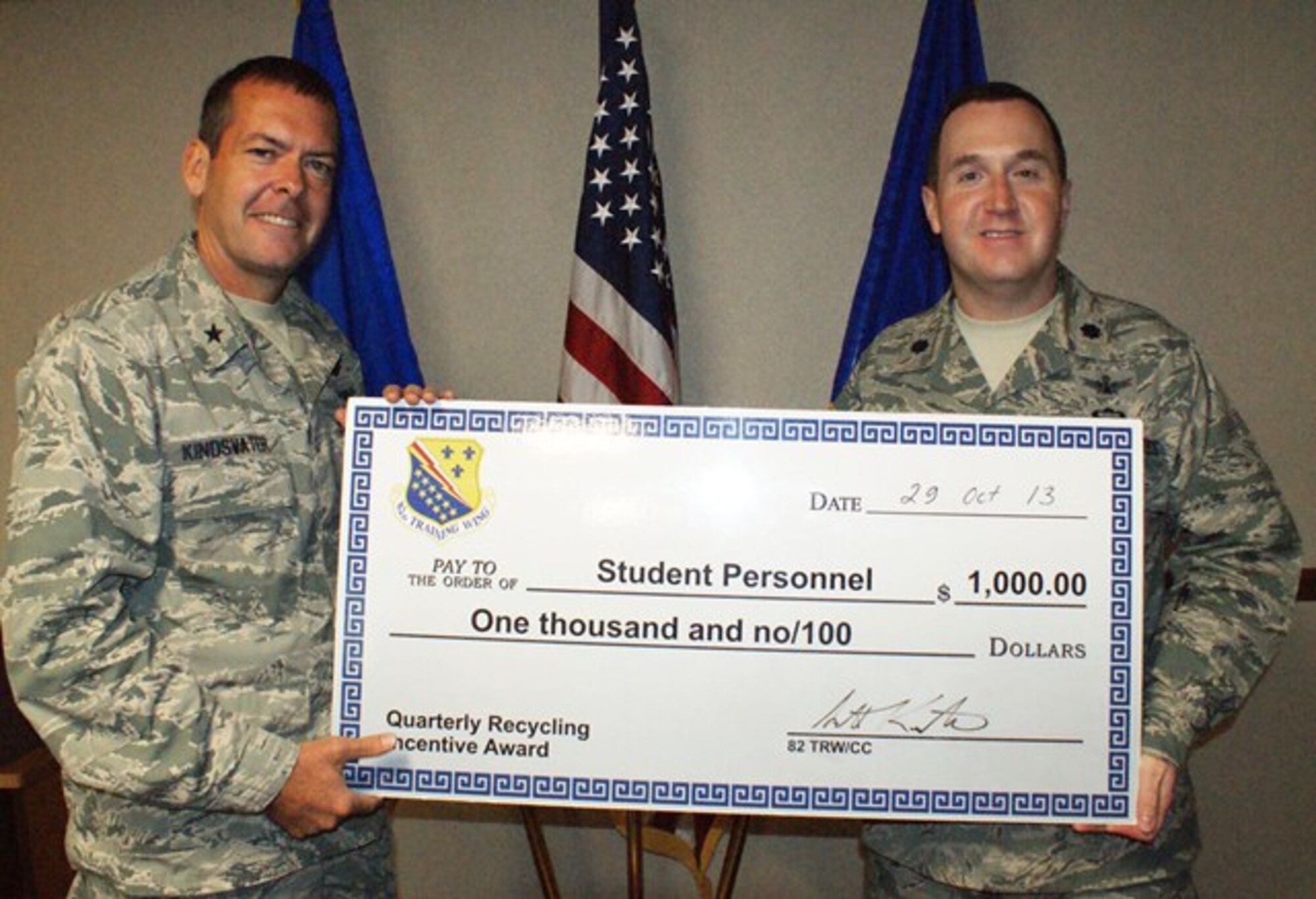 Brig Gen. Scott Kindsvater (left), 82nd Training Wing commander, congratulates 782nd Training Group deputy commander Lt. Col. Paul Lips on the group's efforts in taking home the FY13, 4th Quarter Recycling student award Oct 30, 2013. The 782nd TRG recycled just over three pounds per group person this quarter. (U.S. Air Force photo/Dan Hawkins)